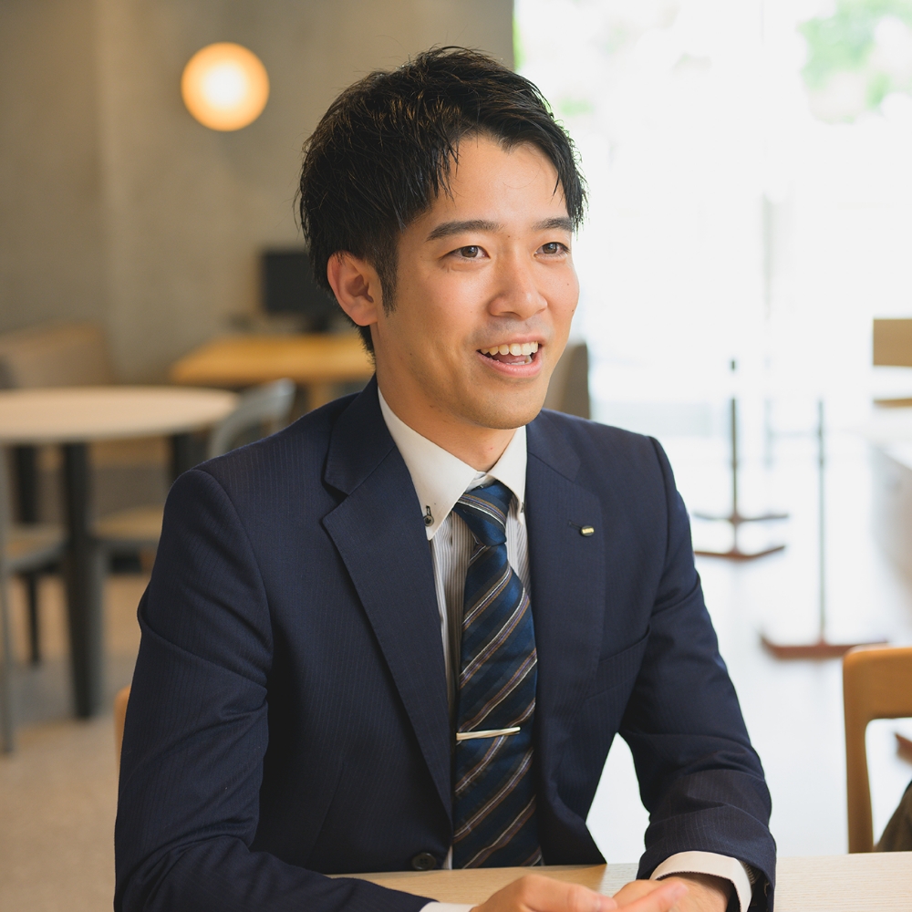 スーツ姿の男性が笑顔で話している